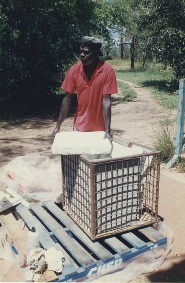 Artist: b'Tremblay, Theo.' | Title: b'Andrew Margalulu at Bula Bula Arts with lithographic stones for Theo Trenblay print workshop, Ramingining, April 1997.' | Date: April 1997